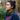 Amalia is wearing Bluey's long chute in colour olive green around her neck. She is looking up at the trees around her. Amalia is also wearing the women's Finley Merino t-shirt in the colour Dark Bridestowe and the Women's Full Zip 340 Jacket. She is photographed standing in the middle of nature, in Hollybank reserve, Northern Tasmania. Photography by Melanie Kate Creative -  © Bluey Merino